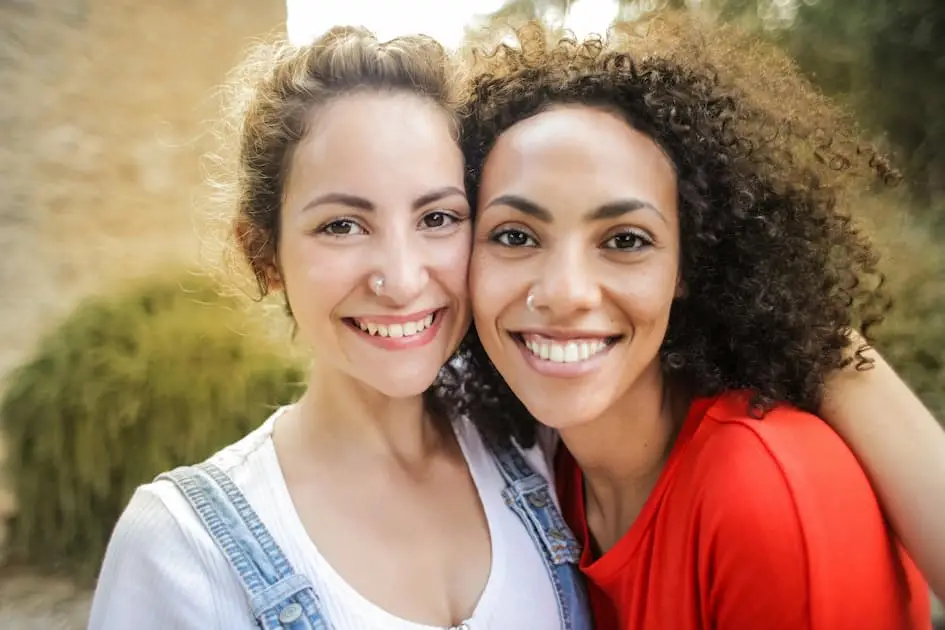 Two happy women posing for a photo, celebrating their friendship and alignment with God’s purpose in their lives.